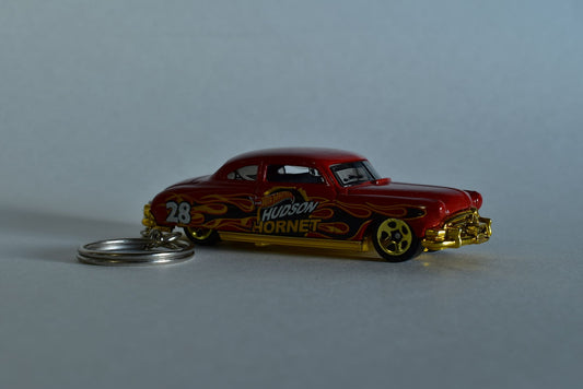 Red Hotwheels Hudson Hornet keychain on a white background