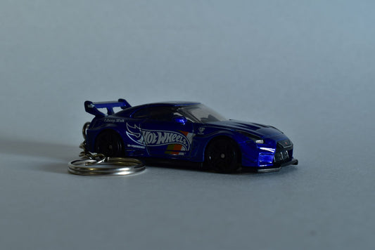 Blue Hotwheels Nissan GTR Liberty Walk keychain on a white background