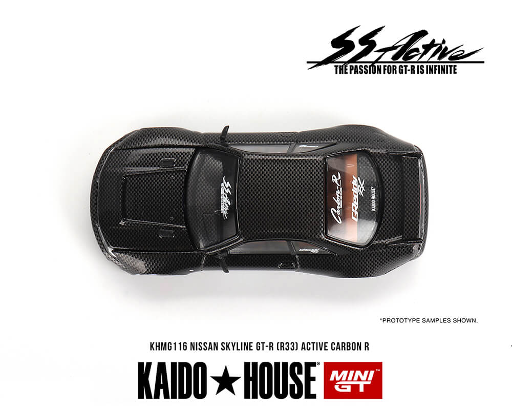 Top down view of a Mini GT Kaido House Nissan GT-R R33 Active Carbon R diecast car on a white background.